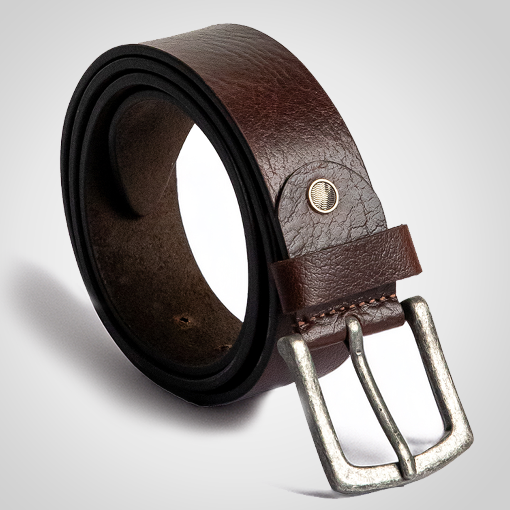 Brown leather belt with silver buckle on a light gray background