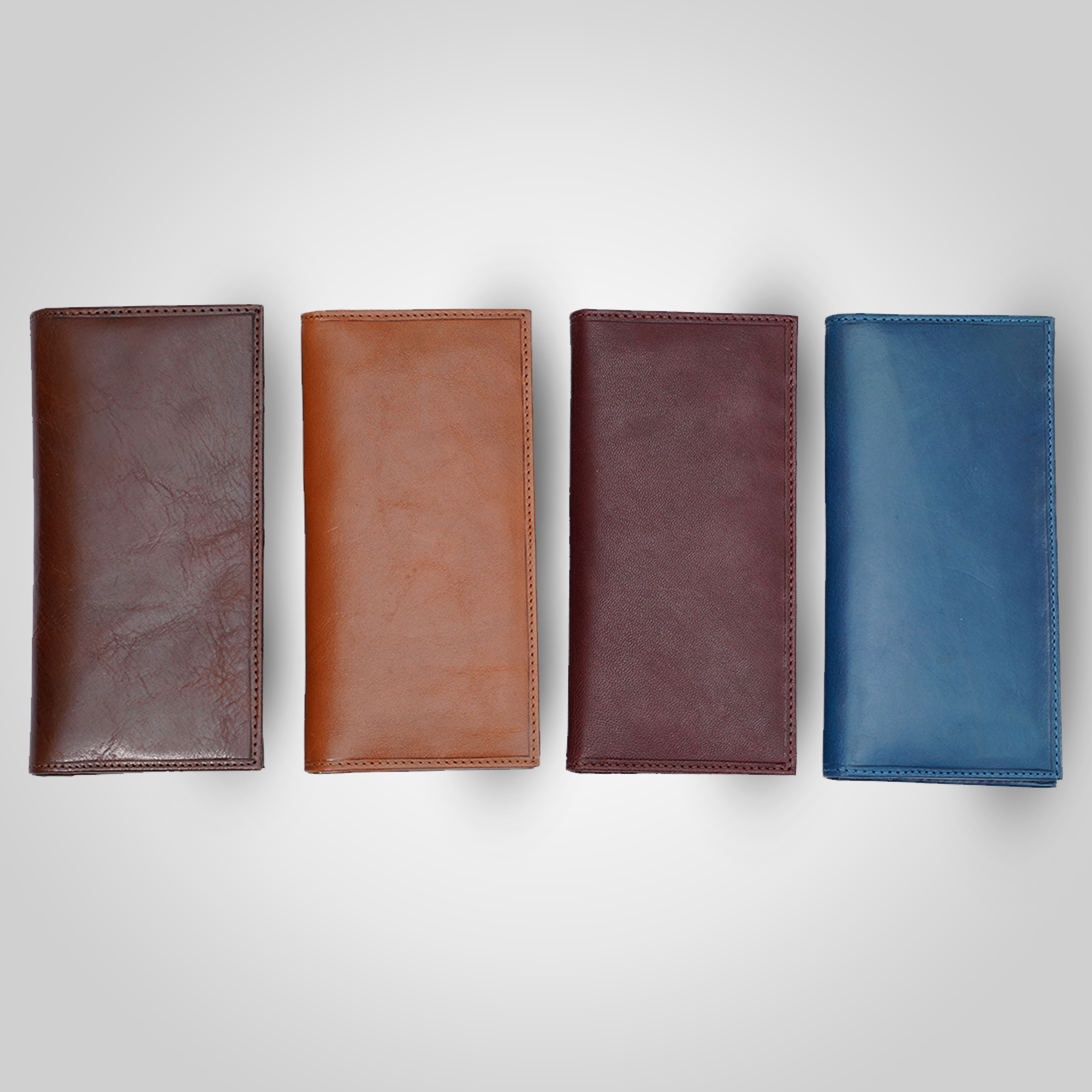 Four leather wallets in different colors arranged on a light gray background
