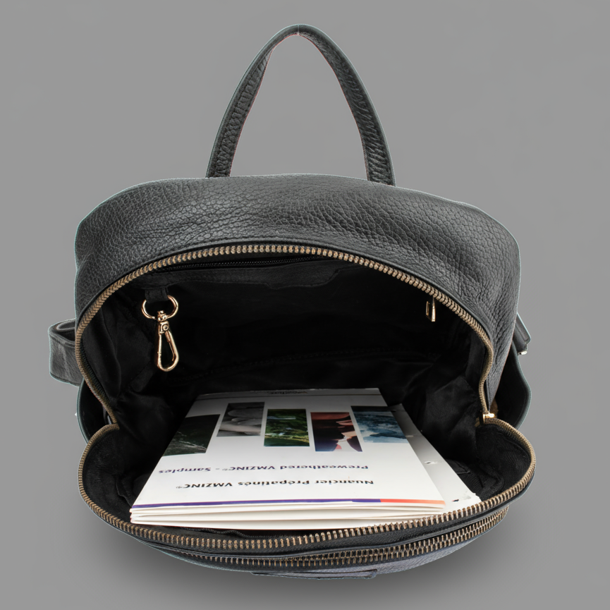 Black backpack with open front compartment showing printed materials on a gray background