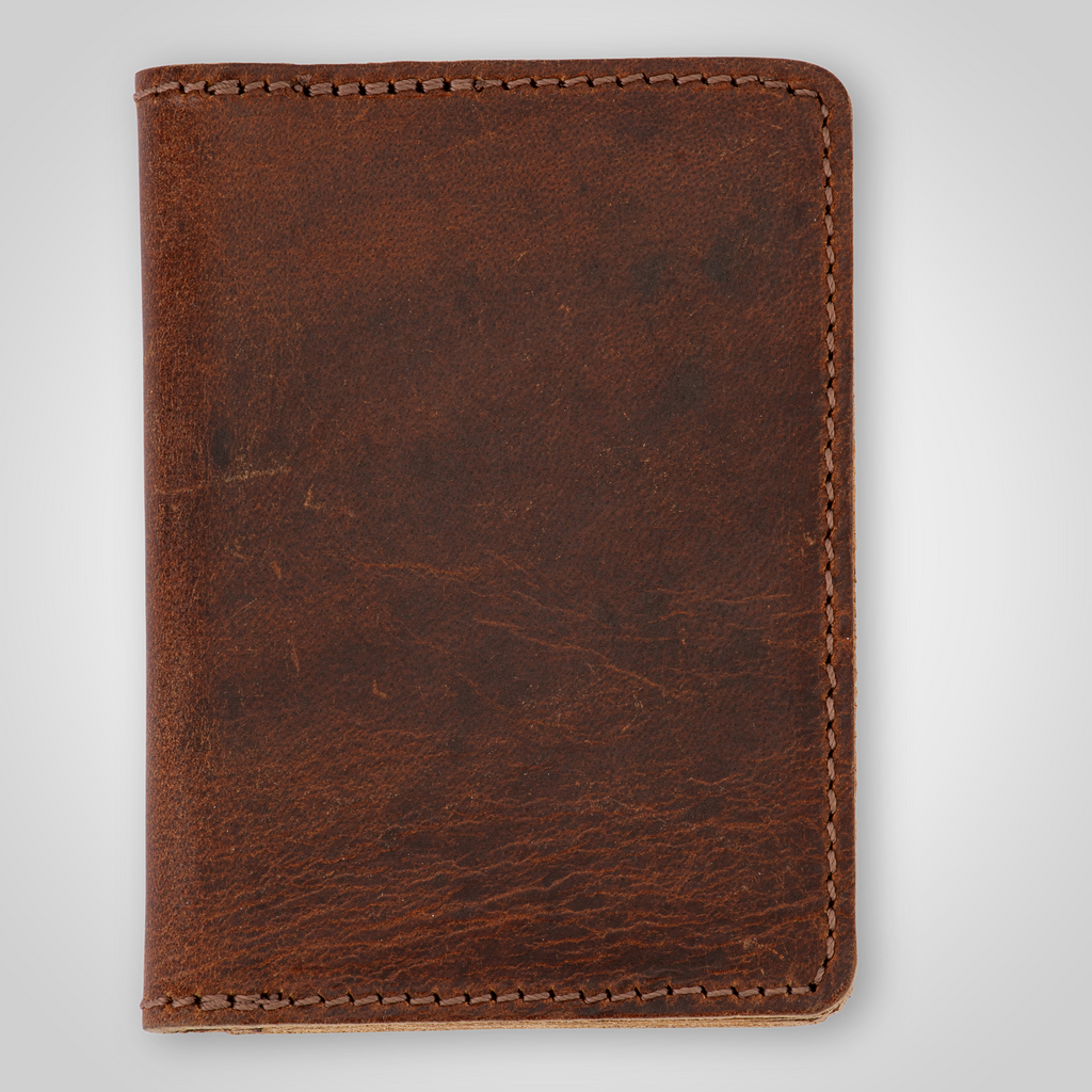 Brown leather card holder on a light gray background