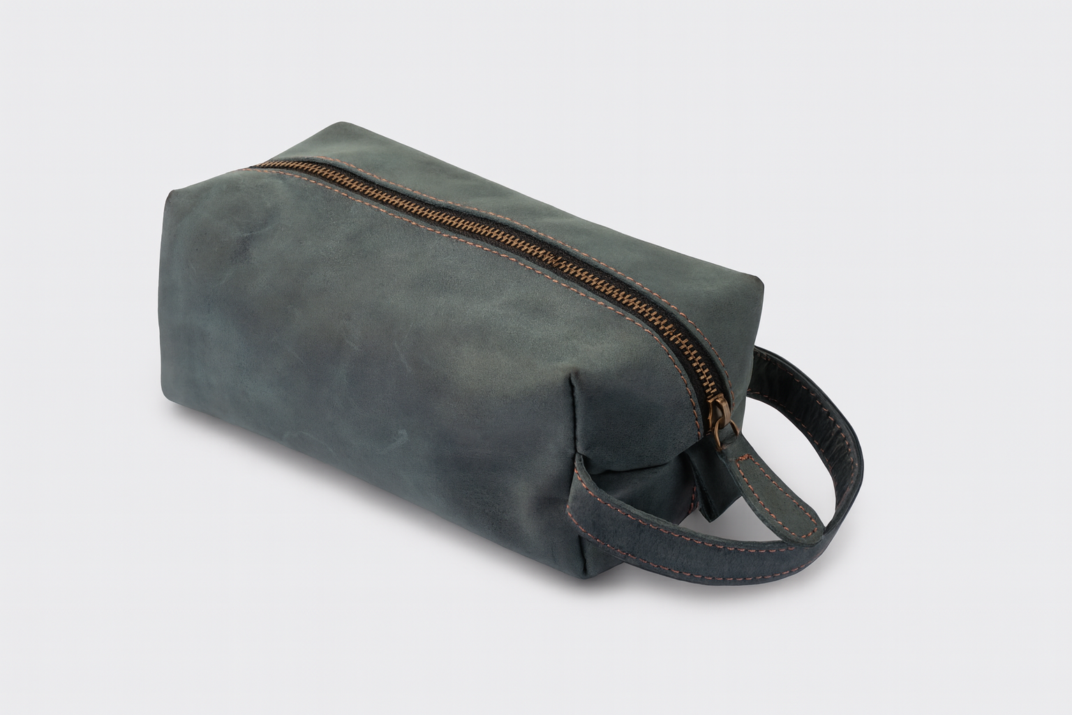 Gray toiletry bag with a handle on a light gray background