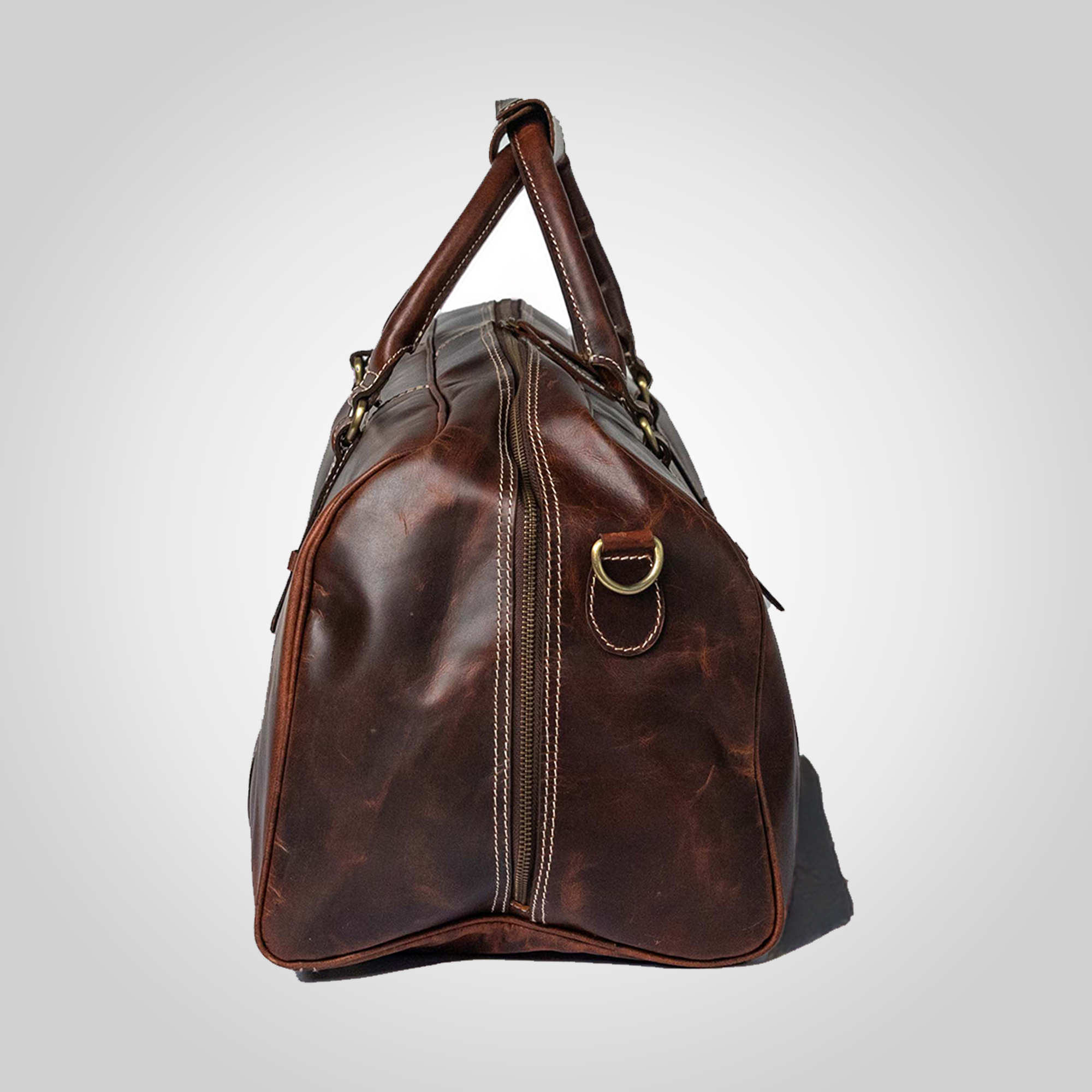 Classic brown leather duffle bag with structured silhouette and brass hardware