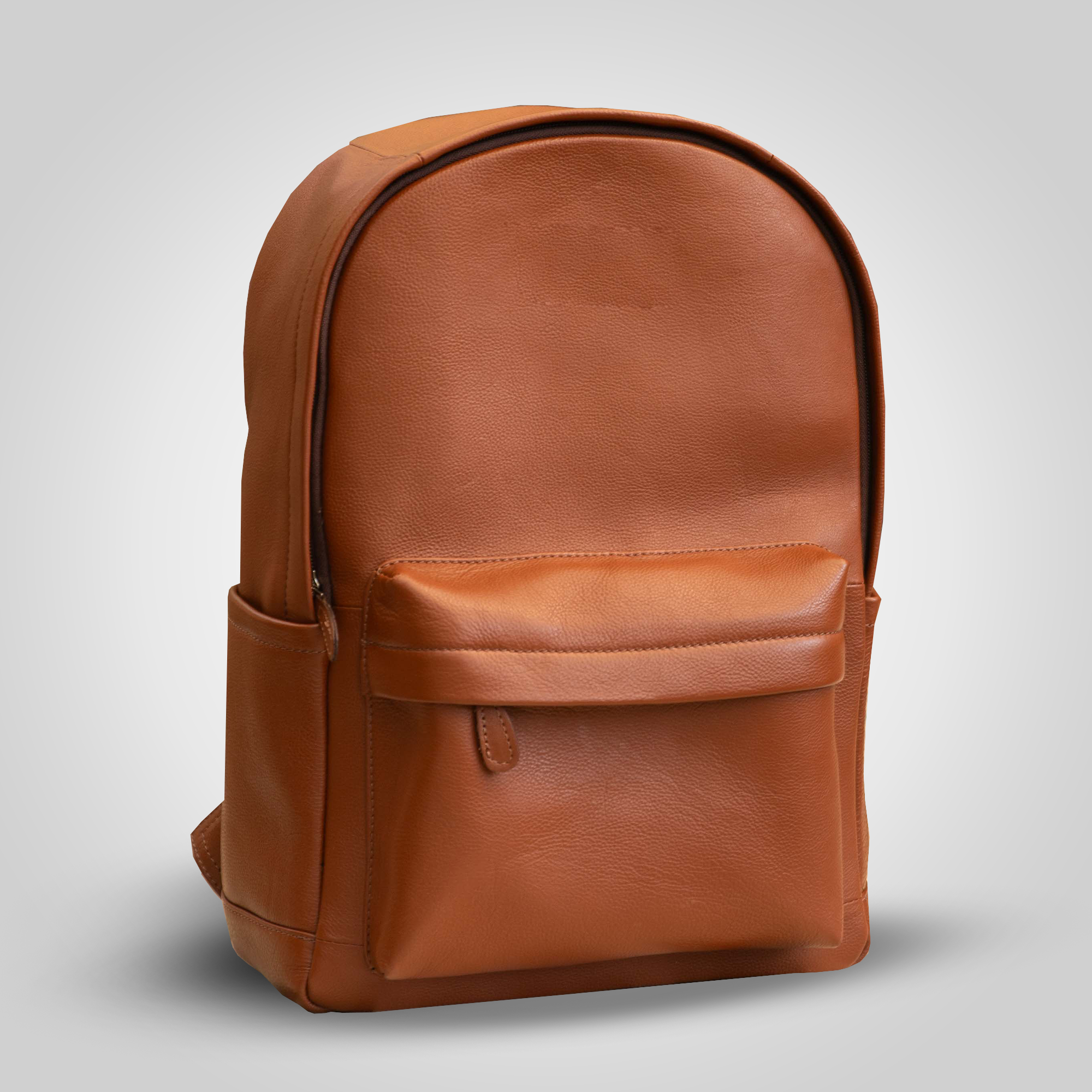 Brown leather backpack on a light gray background