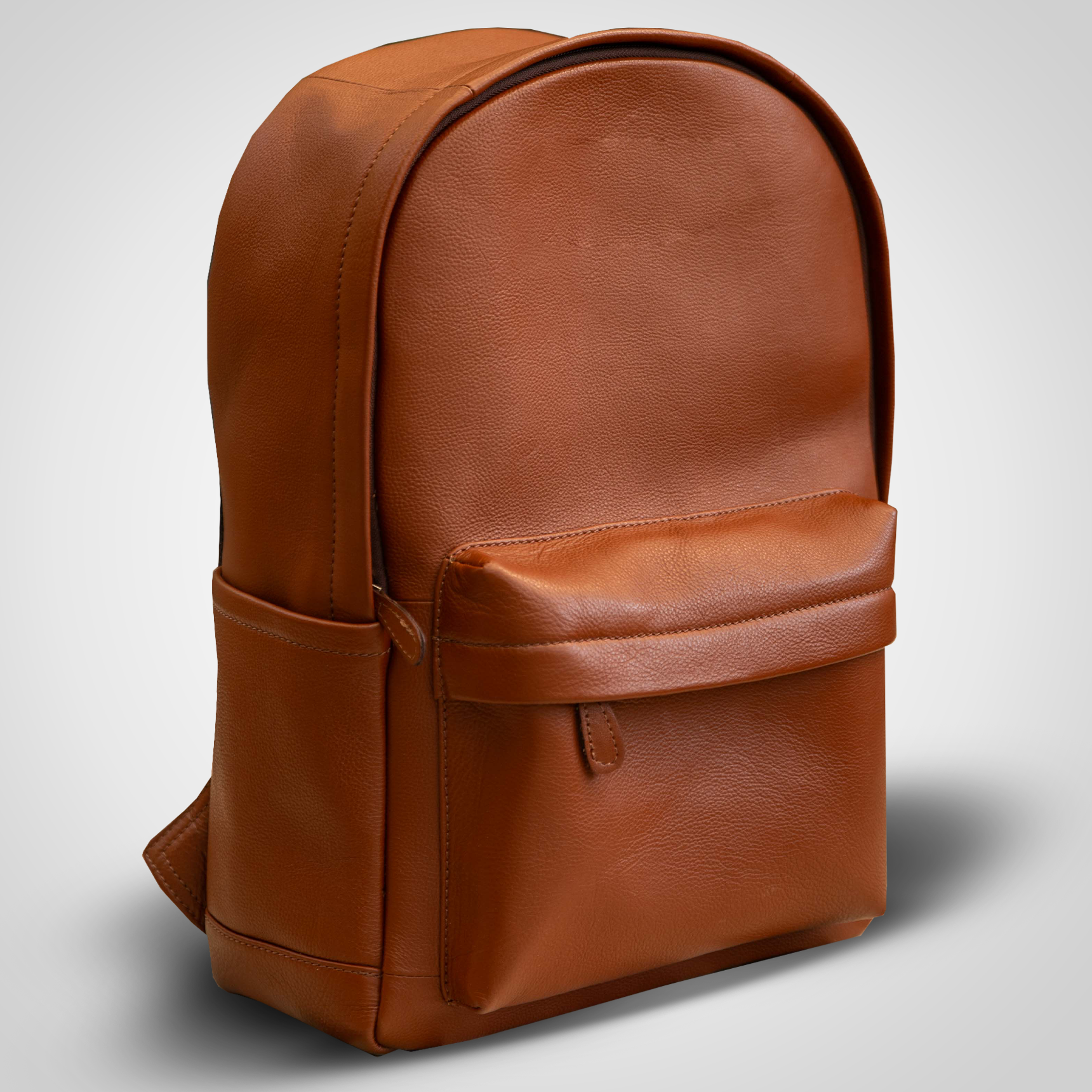 Brown leather backpack on a light gray background