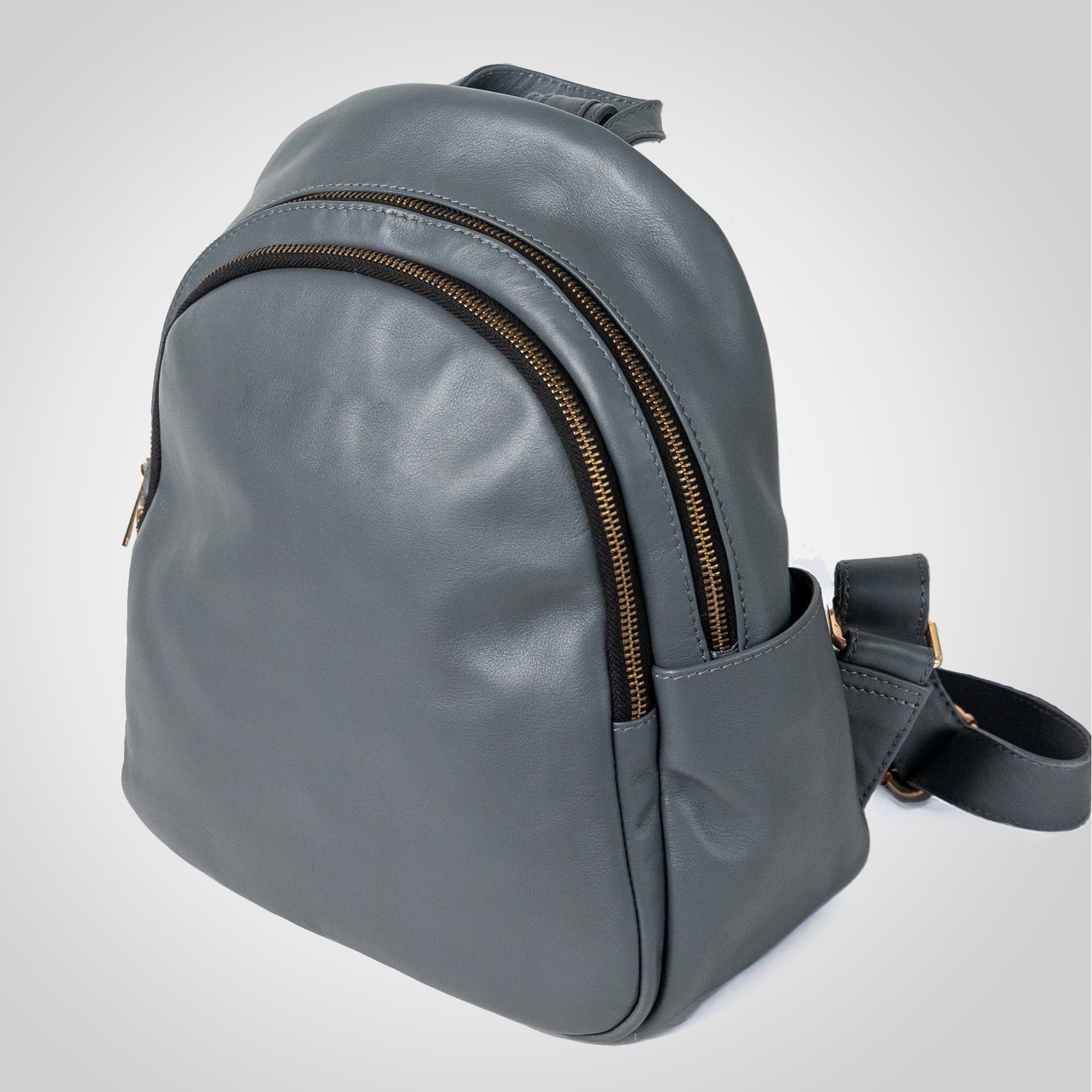 Side view of The Grace grey leather backpack showing quilted texture and metallic accents