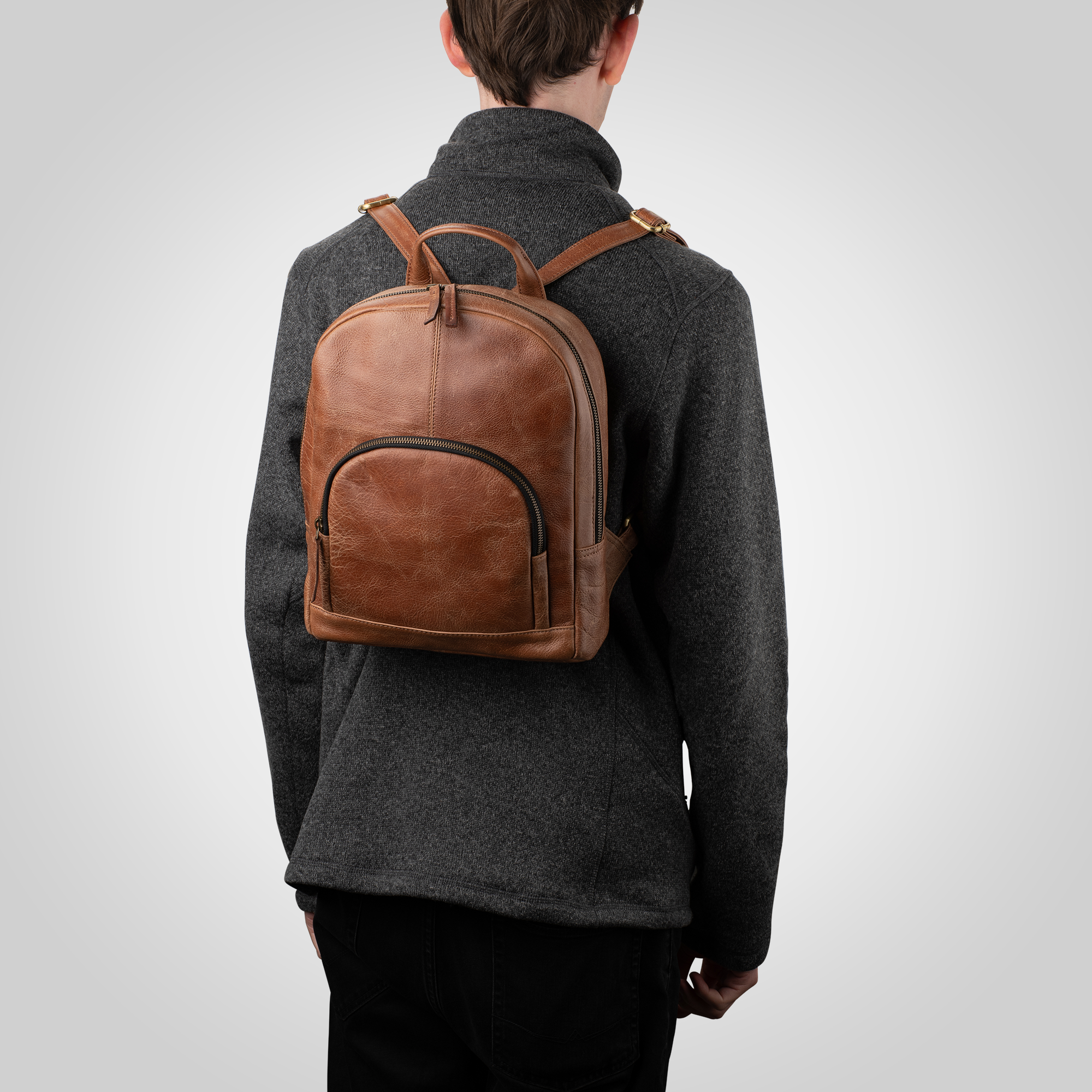 Man wearing The Nomad full grain leather backpack during commute or travel