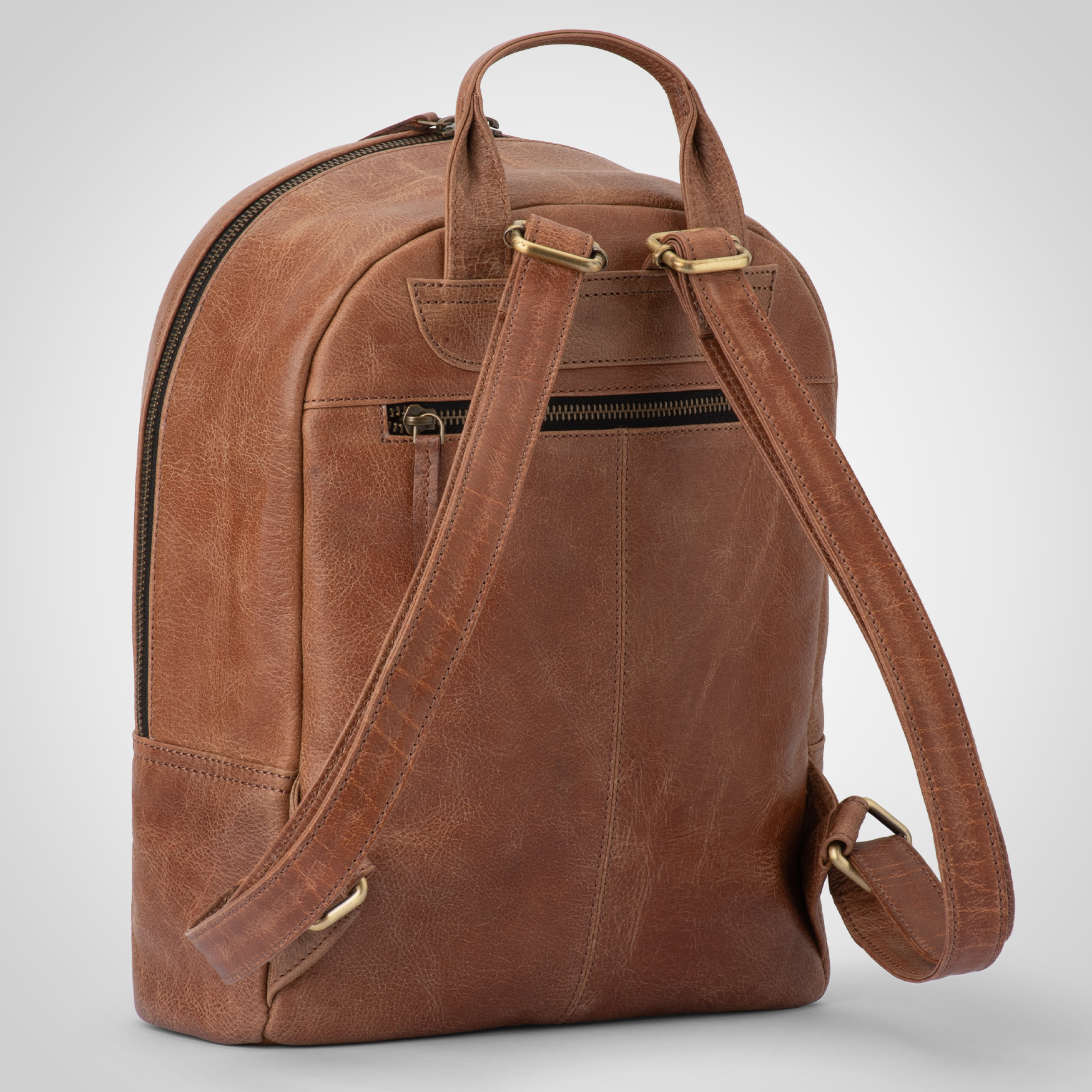 Side view of The Nomad genuine leather backpack showing sleek silhouette and premium stitching