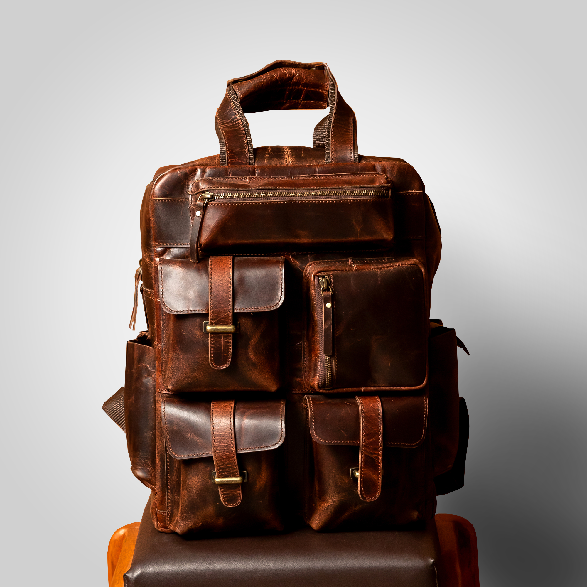 The Pathfinder brown leather backpack placed on table – minimal, modern travel style